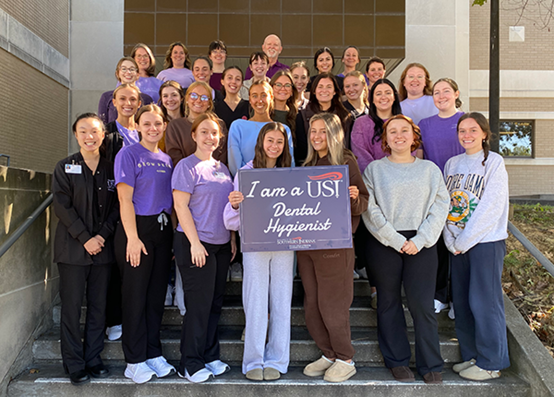 Dental Hygiene students and faculty holding sign that says "I am a USI Dental Hygienist"