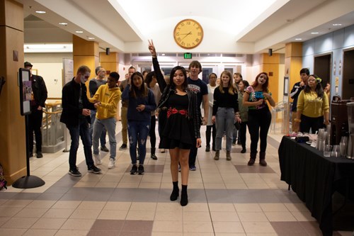 A student leads a Latin dance lesson to a great crowd