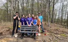 A Scouting Troop helps a 2025 Eagle Scout install some benches on Bent Twig Trail. 
