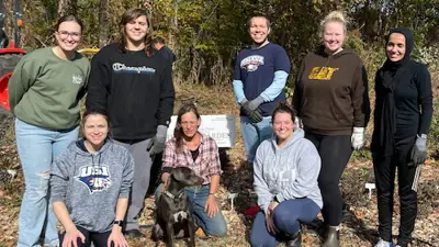Members of biology club volunteer outdoors