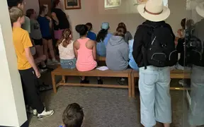 Students learn about astronaut Gus Grissom during an educational museum presentation.