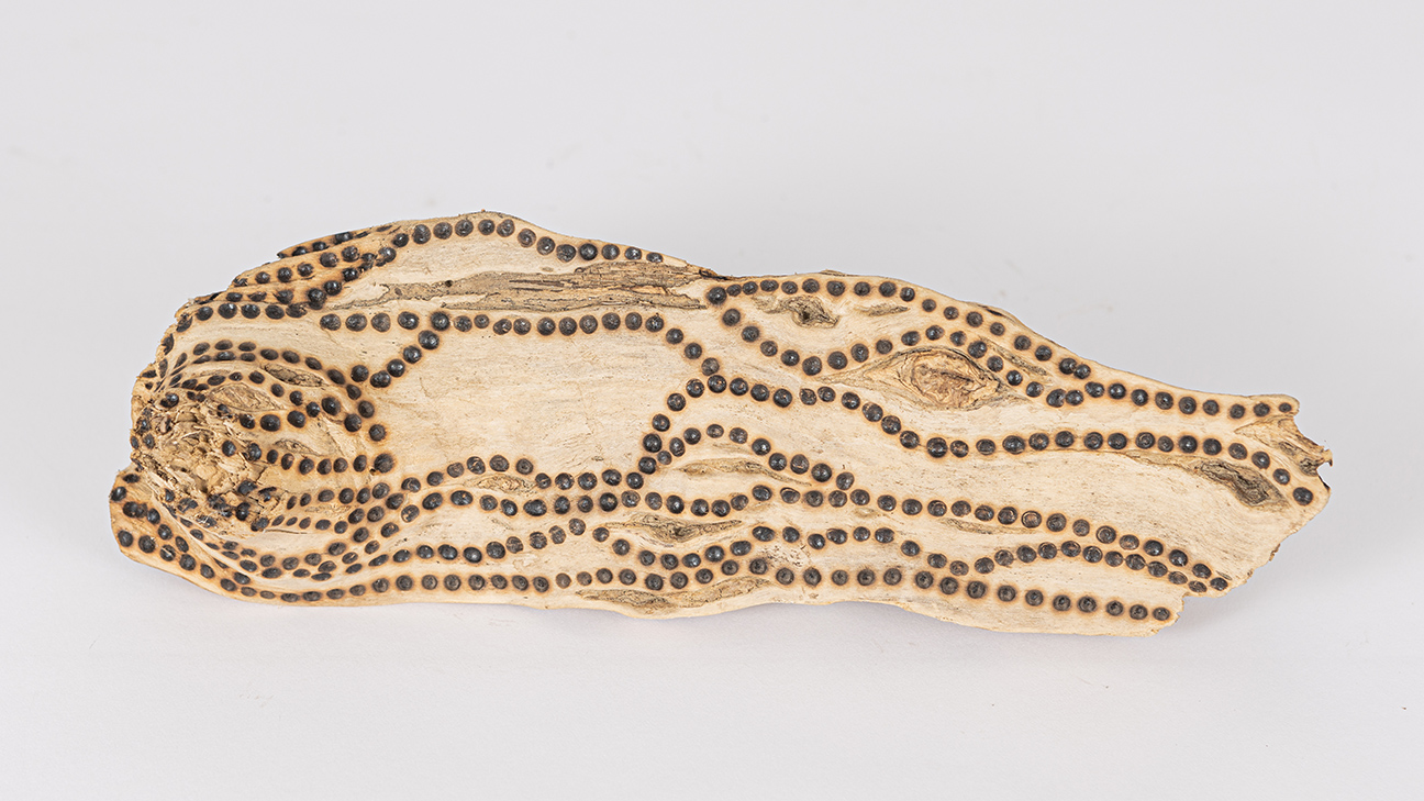 tattooed wood art piece