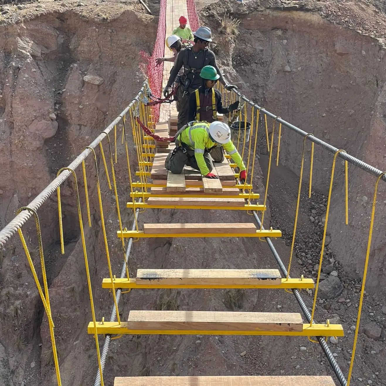 USI students do engineering fieldwork building a suspension footbridge