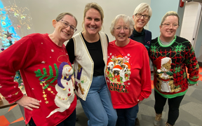 Kinney College staff and faculty wearing holiday attire