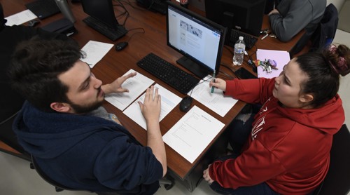 Students work together on Computer Science classwork.