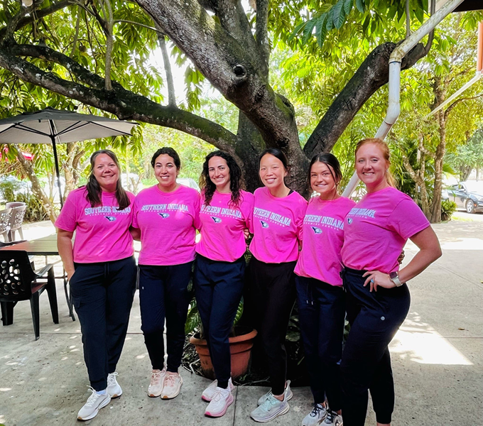 Students and faculty wearing pink USI shirts