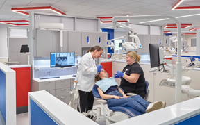 Student and faculty with a patient at the dental clinic