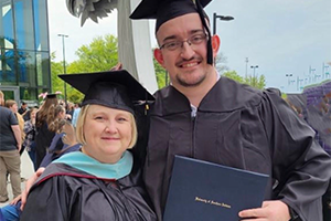 Jody Delp with student at graduation