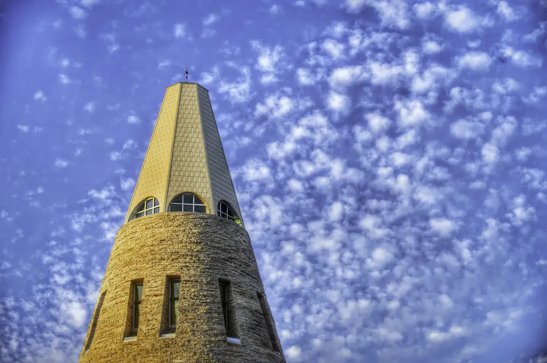 The top of the University Center tower with a blue sky