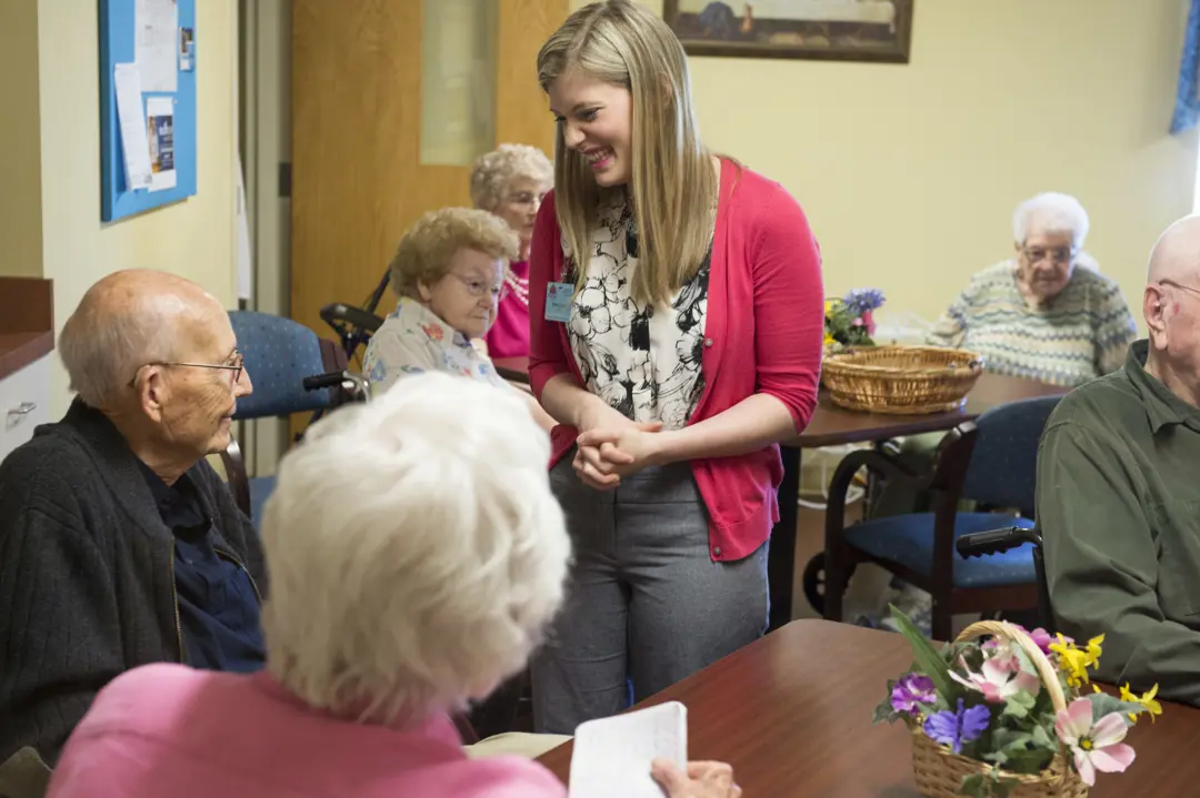 AIT student talking with nursing home residents