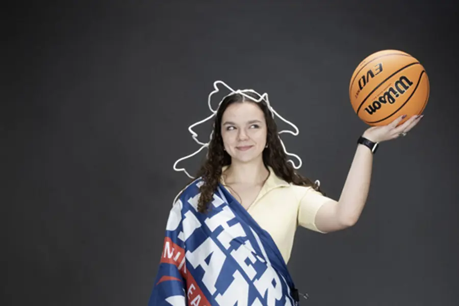 A member of the homecoming court is decked out like the Statue of Liberty using props from the photo studio for one of her homecoming photos. 