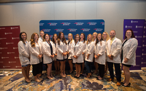 Group of USI students with white coats at Stone Center opening