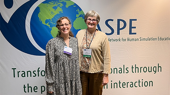 Carly Andrews and Beth Thompson at a conference