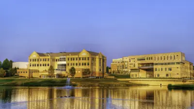 View of the Liberal Arts Center and Business and Engineering Center from Reflection Lake at sunset