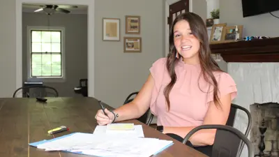 Student working at a desk in an office