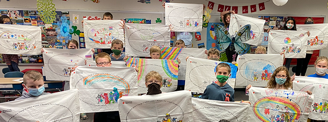 Students holding decorated pillowcases