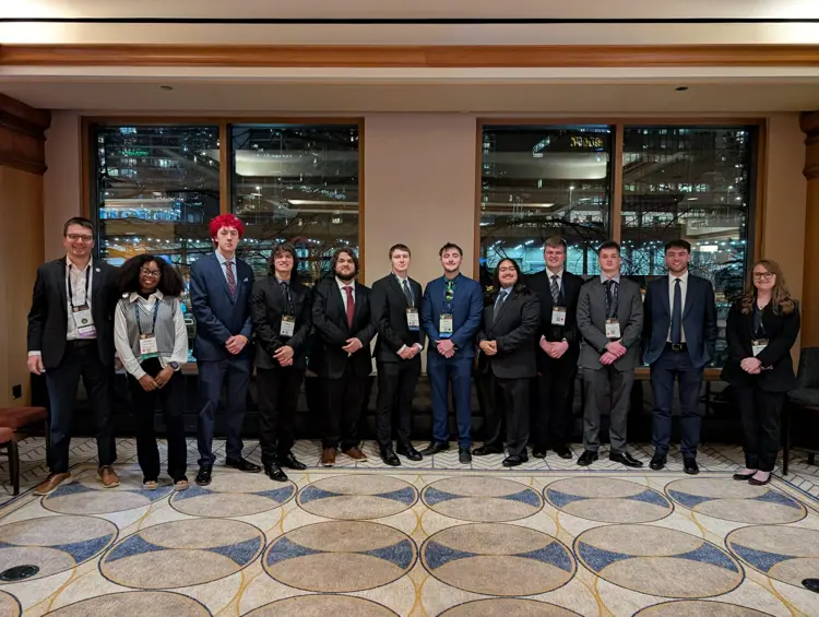 Members of the USI student American Marketing Association pose in professional attire at the 2026 International Collegiate Conference