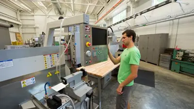 A student programs a CNC machine in the Applied Engineering Center