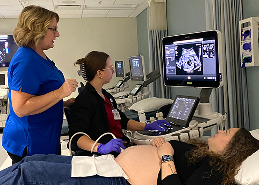 Pregnant woman volunteering to have an ultrasound in sonography lab
