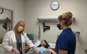 Nutrition students use the clinical simulation center during a class