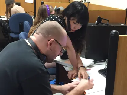 Language tutor assists a student with homework in the Miller Language Lab