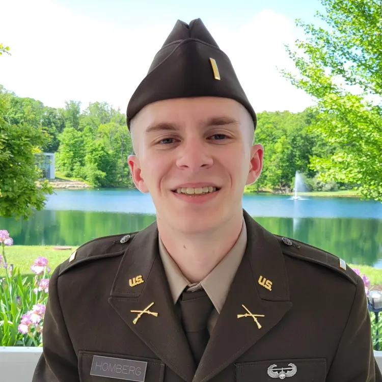 Casual portrait of USI political science graduate Justin Homberg '24 in his military uniform