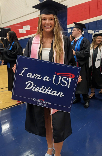 Student holding a dietitian sign