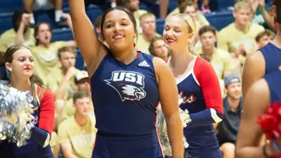 USI cheerleader waves pom poms at an athletic event