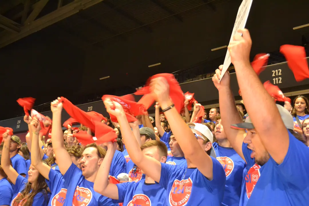 Students wave rally towels in support of their Screaming Eagles athletics teams