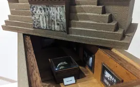 Decorative wooden box with a lid and a miniature art exhibit inside