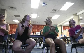 Students laugh together as they sit in a University Center meeting room