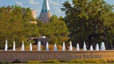 University of Southern Indiana entrance with fountain roundabout and University Center Tower in the background