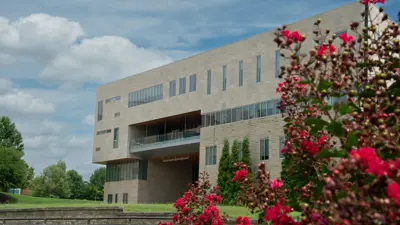 Exterior view of the Business and Engineering Center with a flowering bush in the foreground