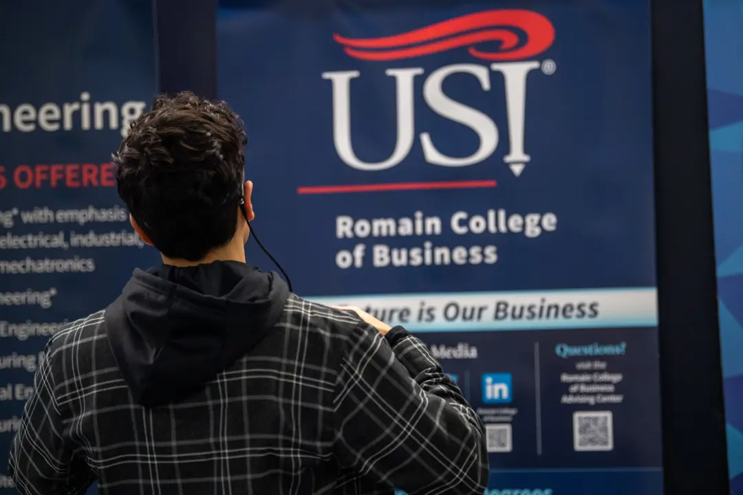 A student looks at a USI banner with eye-tracking glasses.