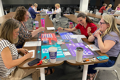 Faculty playing board game simulation called Friday Night at ER