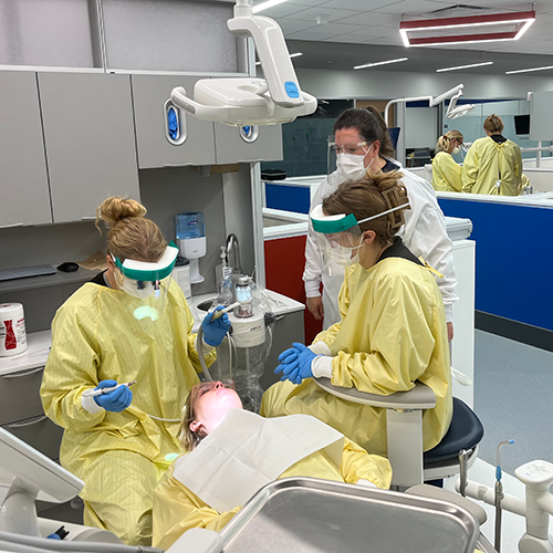 students in dental clinic in training with lasers