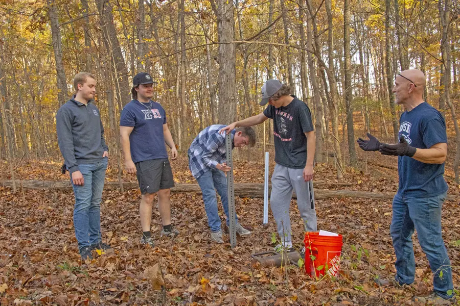 Students installing posts for the directional signage along trails at the 1st Trail Clean Up and Weed Wrangle. 