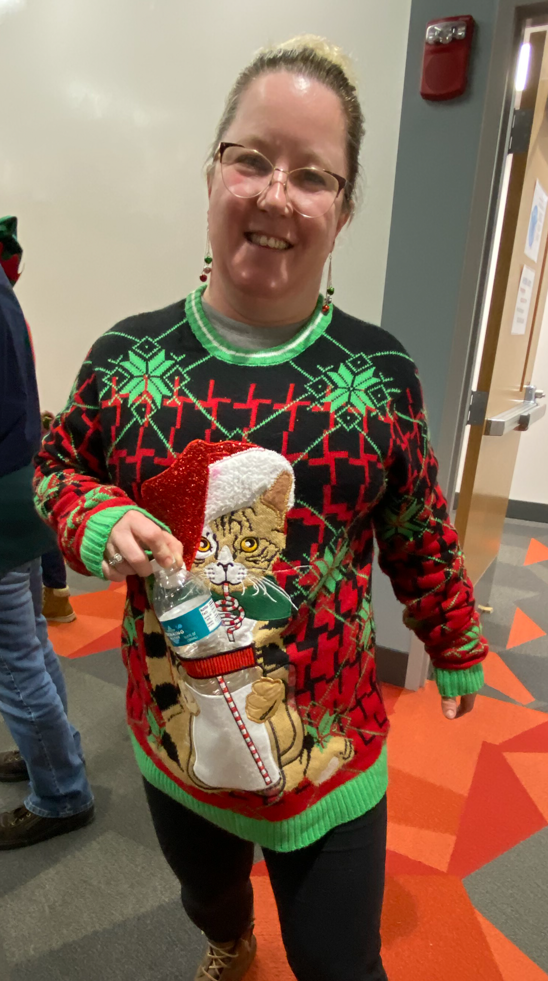 Photo of woman wearing a cat ugly sweater 