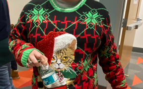 Photo of woman wearing a cat ugly sweater 