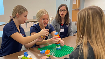 Students using legos during team building activity