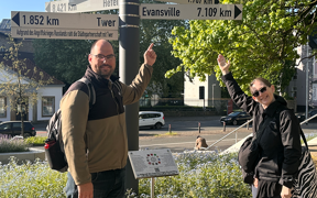 Two faculty members by directional sign in Germany