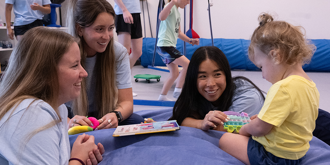 Students doing OT ctivities with a child
