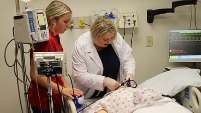Jody Delp helps nursing students with intubation