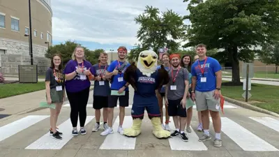 New students pose with Archie Eagle in the University Boulevard crosswalk