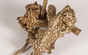 tattooed wood art piece