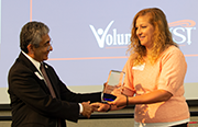 Photo of Jennifer Fehrenbacher receiving trophy