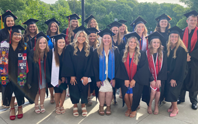 large group of radiology students in caps and gowns at graduation
