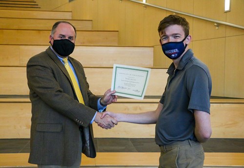 Thomas presenting certificate to Daniel