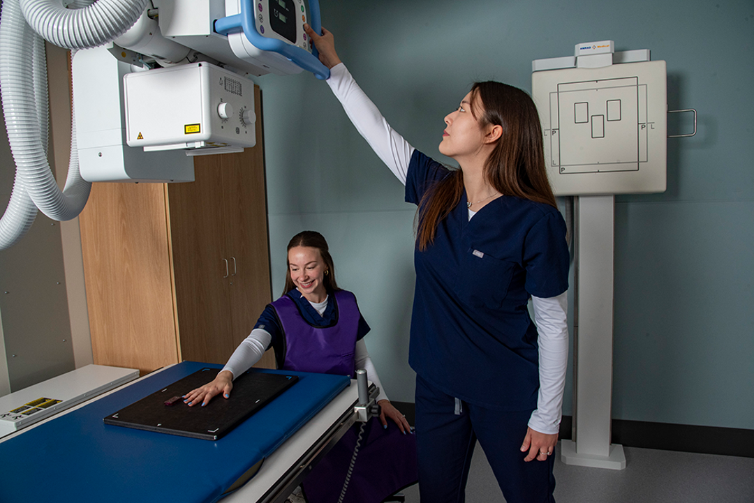 Students practicing with X-ray machine
