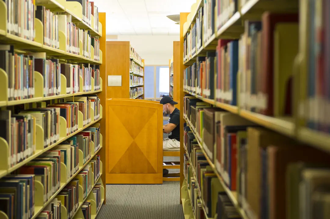 A student studying in Rice Library